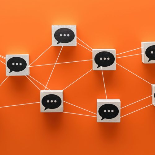 A series of wooden blocks with speech bubbles connected by strings